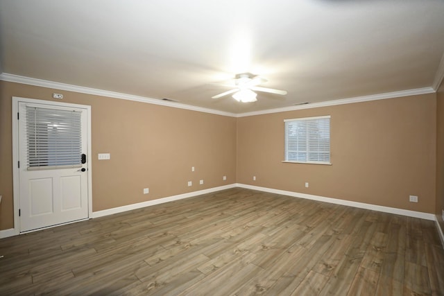 empty room featuring ceiling fan, ornamental molding, and hardwood / wood-style floors