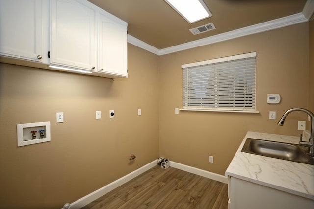 clothes washing area with sink, hookup for a washing machine, cabinets, crown molding, and electric dryer hookup