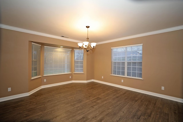 spare room featuring a chandelier, dark hardwood / wood-style floors, and ornamental molding