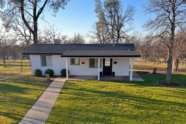 single story home featuring a front yard, a patio, and central AC unit