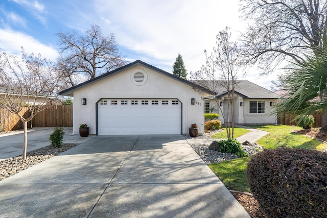 ranch-style home featuring driveway, a garage, fence, and stucco siding