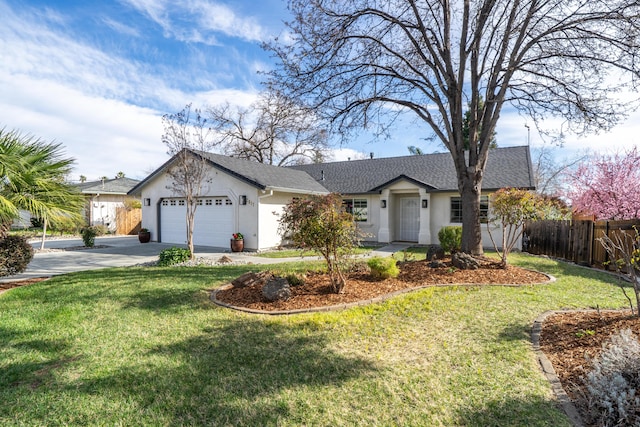 ranch-style home with a garage, a front yard, and fence