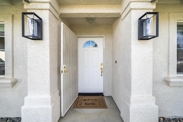 entrance to property with stucco siding