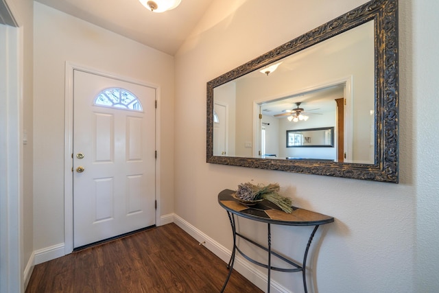 entryway featuring vaulted ceiling, dark wood finished floors, and baseboards