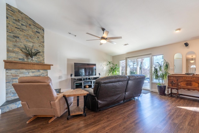 living room featuring dark wood-style flooring, visible vents, vaulted ceiling, and ceiling fan