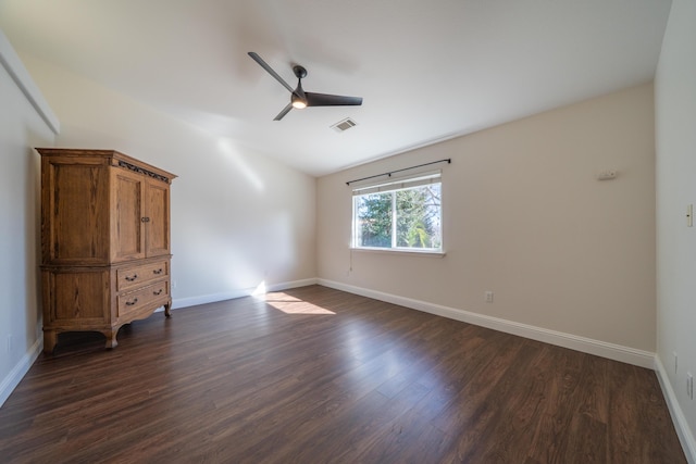 unfurnished bedroom with baseboards, visible vents, a ceiling fan, lofted ceiling, and dark wood-type flooring