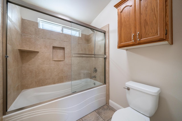 bathroom with baseboards, shower / bath combination with glass door, and toilet