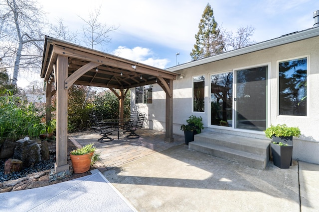 view of patio featuring entry steps, a gazebo, and outdoor dining space