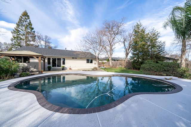 view of swimming pool featuring a patio area, fence, and a fenced in pool