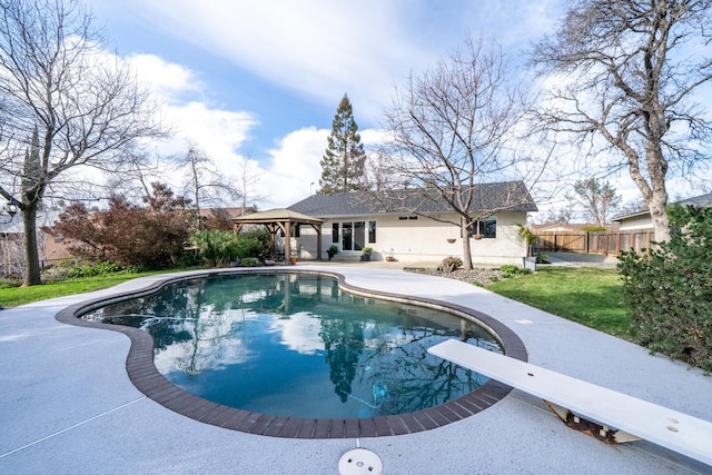 view of swimming pool with a fenced in pool, a lawn, a gazebo, fence, and a diving board