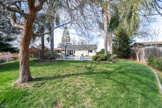 view of yard with a gazebo, fence, and a pool