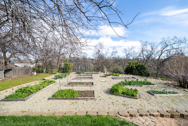 view of yard with a vegetable garden and fence