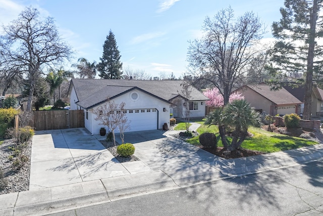 ranch-style house with an attached garage, fence, driveway, stucco siding, and a front lawn