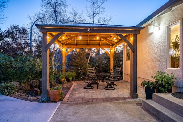 view of patio with a gazebo and outdoor dining area