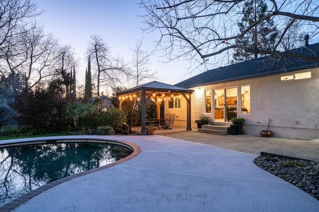 outdoor pool featuring a patio and a gazebo