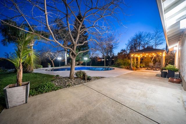 pool with a patio area and a gazebo