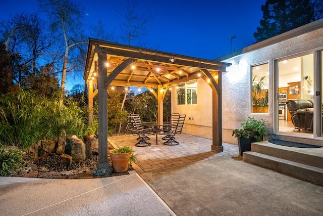 patio at night featuring a gazebo