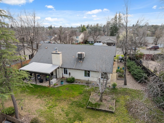 back of property with a patio and a lawn