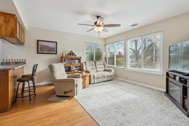 living room featuring hardwood / wood-style floors and ceiling fan