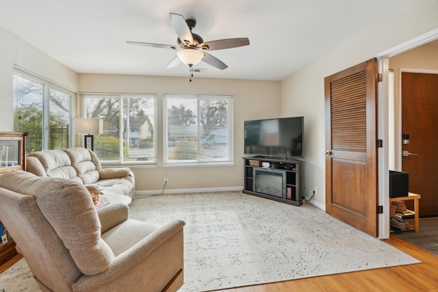 living room featuring light hardwood / wood-style floors and ceiling fan