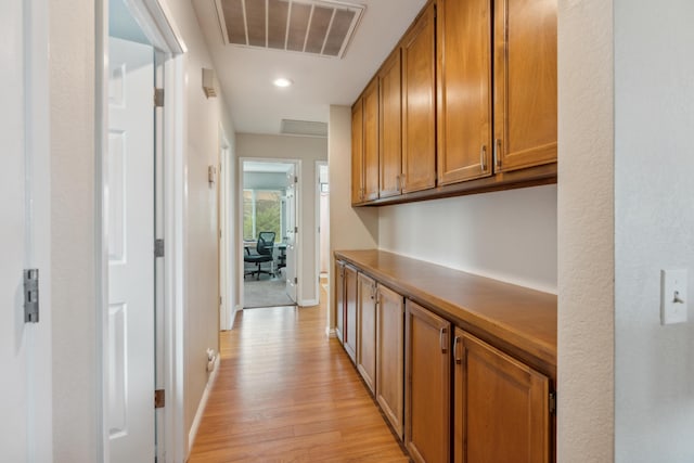 hallway with light hardwood / wood-style floors