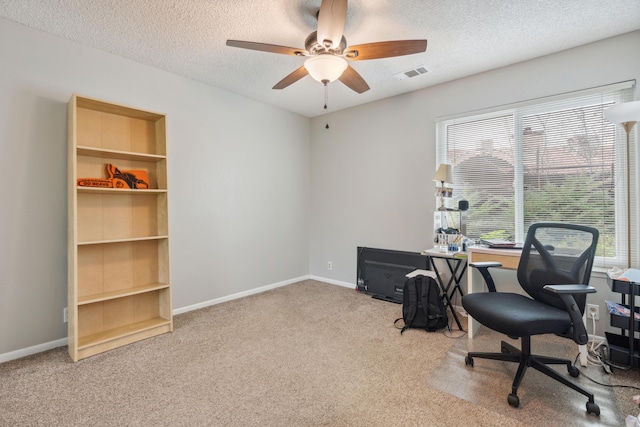 office space featuring ceiling fan, a textured ceiling, and carpet