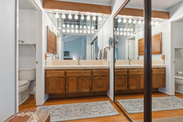 bathroom with vanity, hardwood / wood-style flooring, and toilet