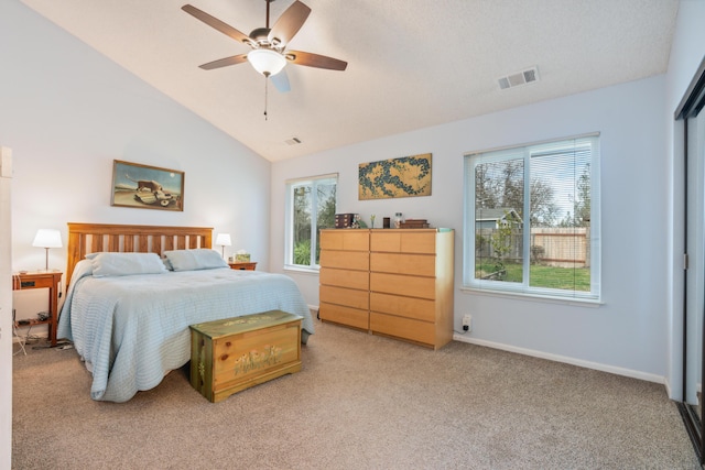 carpeted bedroom featuring ceiling fan, lofted ceiling, and multiple windows