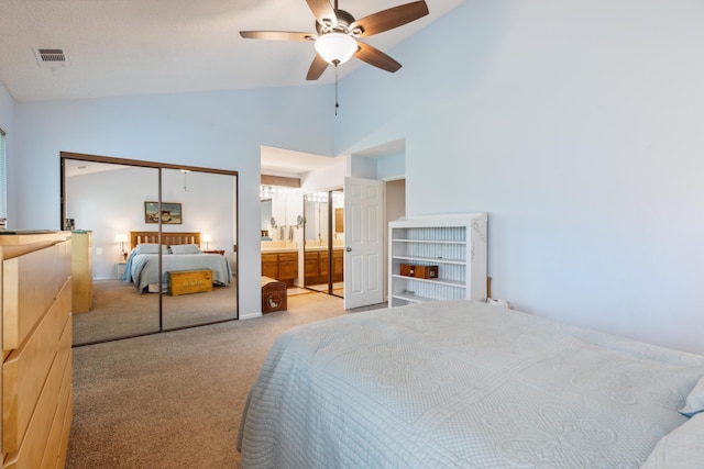 bedroom featuring ensuite bathroom, light colored carpet, high vaulted ceiling, a closet, and ceiling fan