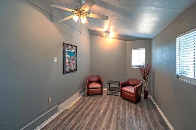 sitting room featuring dark wood-type flooring and ceiling fan