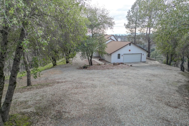 view of front facade featuring driveway, an attached garage, and stucco siding