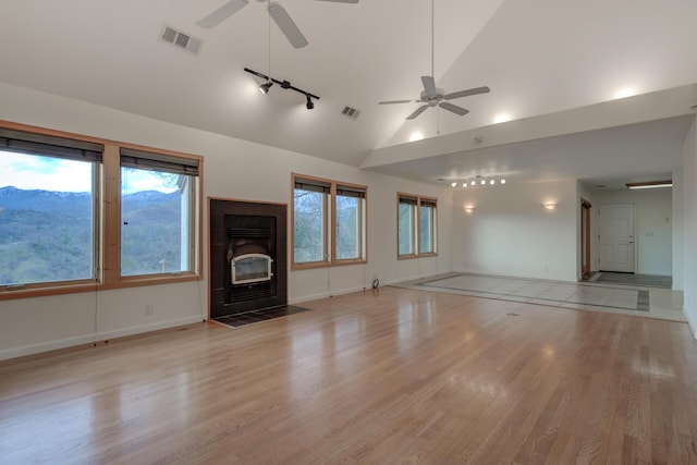 unfurnished living room featuring light wood-style floors, visible vents, and a fireplace