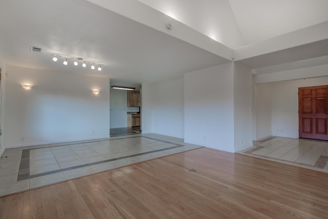 unfurnished room with visible vents and light wood finished floors