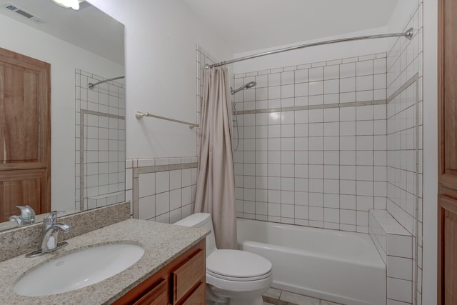 bathroom featuring visible vents, vanity, toilet, and shower / bath combo with shower curtain