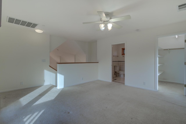 unfurnished living room with ceiling fan, baseboards, visible vents, and light colored carpet