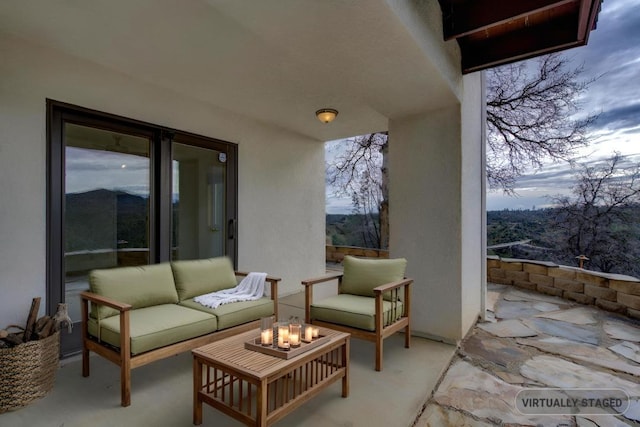 view of patio with an outdoor living space with a fire pit