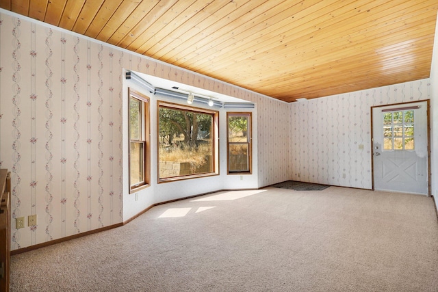 empty room with wood ceiling and carpet floors