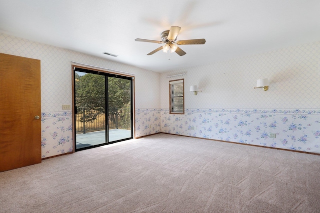 empty room with ceiling fan and carpet