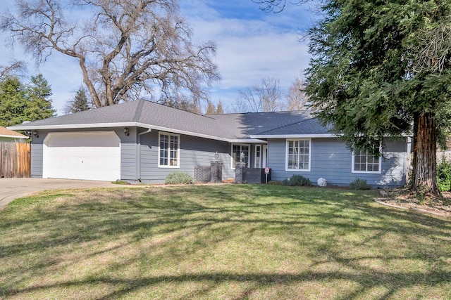 single story home with a garage and a front lawn