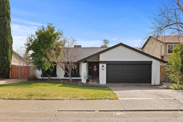 view of front of house with a garage and a front lawn