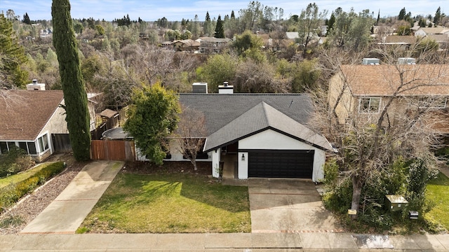 view of front of property featuring a garage and a front lawn