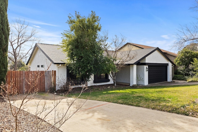 view of front of house with a garage and a front lawn