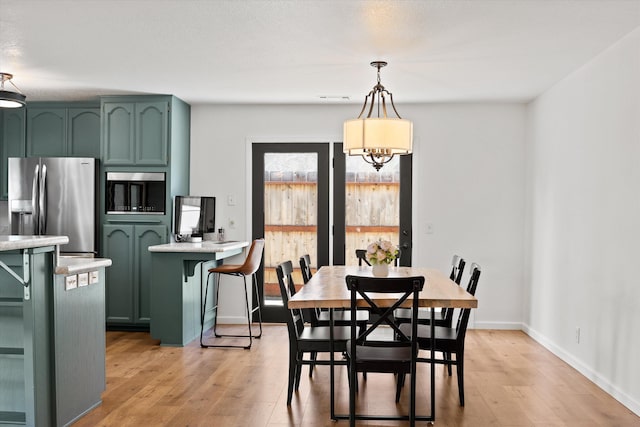 dining space featuring light hardwood / wood-style floors