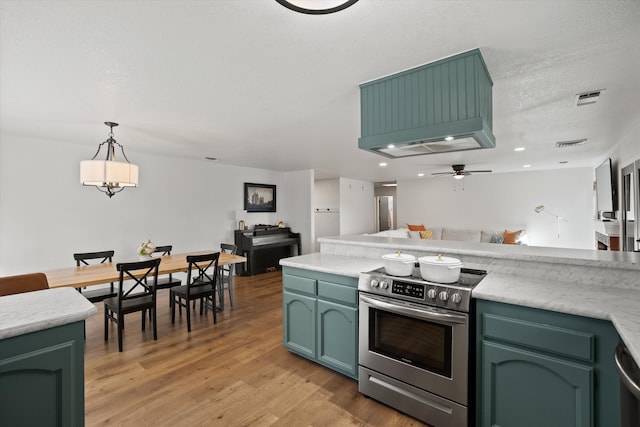 kitchen featuring pendant lighting, ceiling fan, electric range, green cabinetry, and light wood-type flooring