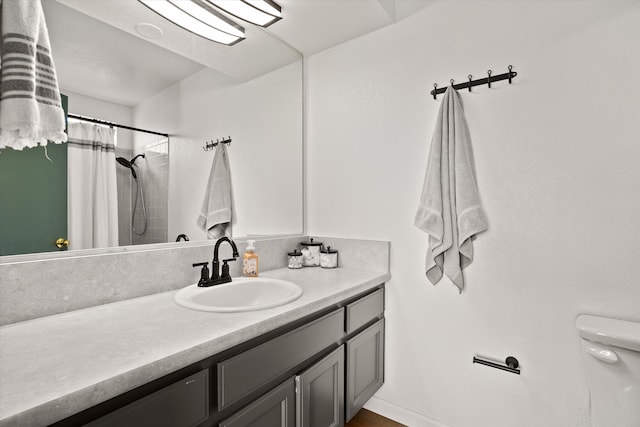 bathroom featuring vanity, toilet, and a shower with shower curtain