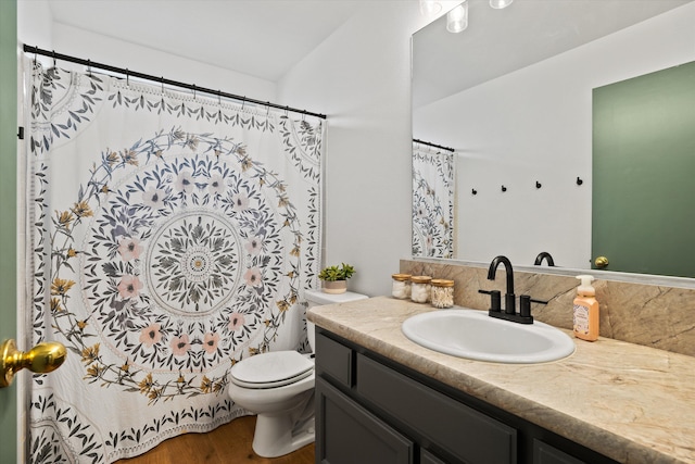 bathroom featuring vanity, hardwood / wood-style flooring, and toilet