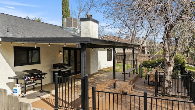 view of patio / terrace with area for grilling, a deck, and central air condition unit