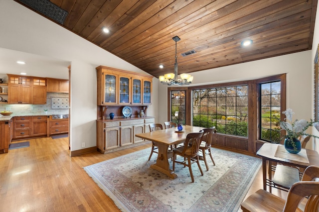 dining area featuring lofted ceiling, wooden ceiling, visible vents, light wood-type flooring, and an inviting chandelier