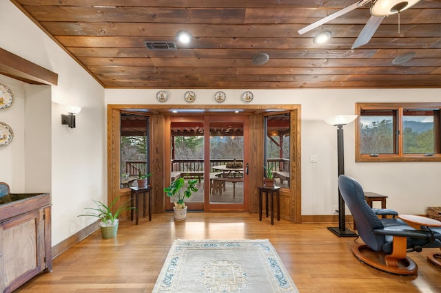 office area with light wood-style floors, wood ceiling, visible vents, and ceiling fan