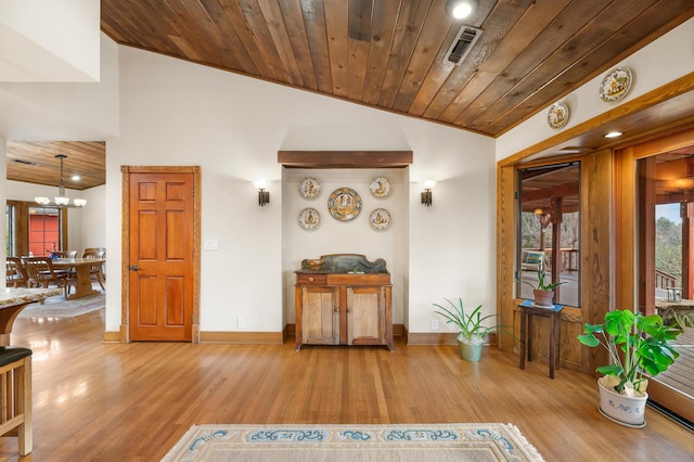 interior space featuring vaulted ceiling, wood ceiling, light wood-style flooring, and visible vents